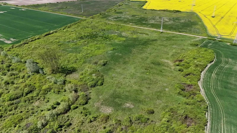 Aerial view of agricultural and forest land in Zemplínske Kopčany with diverse vegetation.