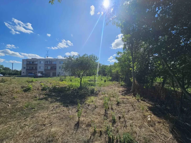 Plots - housing in Hronovce with a grassy area and a residential building in the background.
