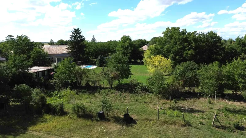 The landscape in Hronovce with residential plots, surrounded by greenery and a rural atmosphere.