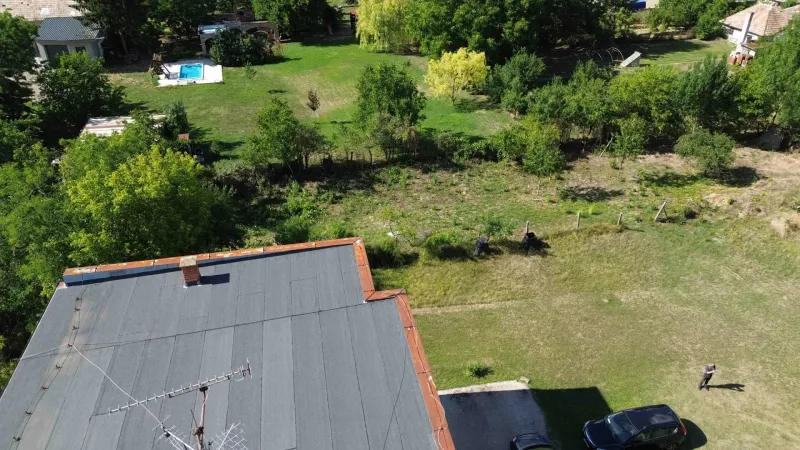 Plots - living in Hronovce: grassy area, trees, pool, roof, open nature.