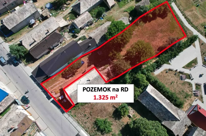 Aerial view of a residential plot in Hrnčiarska Ves, fenced, with surrounding houses.