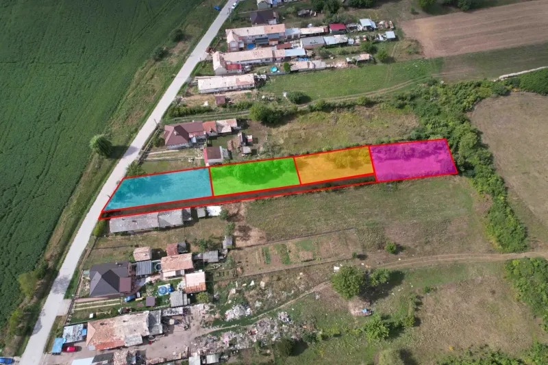 An aerial view of subdivided residential plots in Rakytník near the main road.