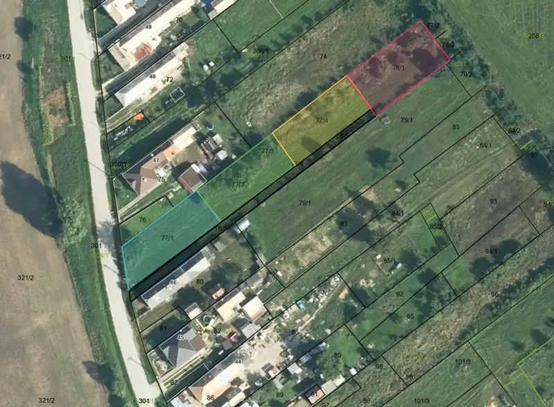 Aerial photograph of residential plots in Rakytník with divided parcels and buildings.