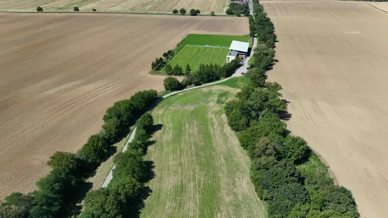Agricultural and forest land in Nová Ves nad Váhom with a playground and a dirt road.