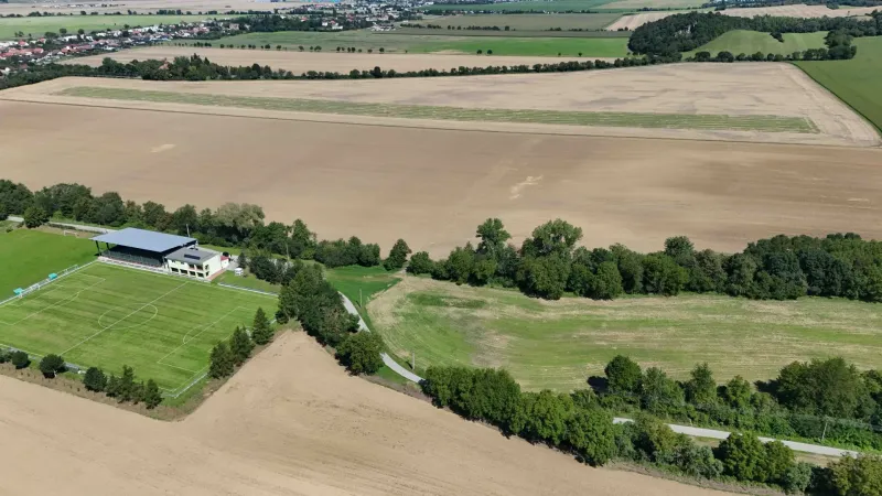 Agricultural and forest land in Nová Ves nad Váhom with a playground and surrounding nature.