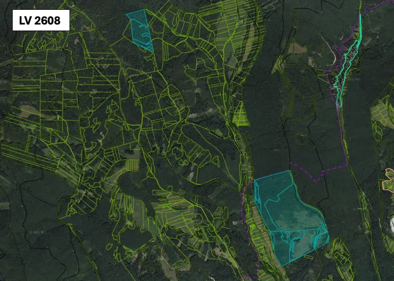 An aerial view of agricultural and forest lands around Brusno.