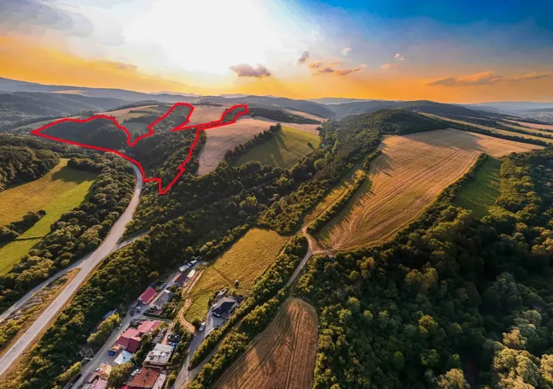 Aerial view of agricultural and forest land in Rokycany at sunset.