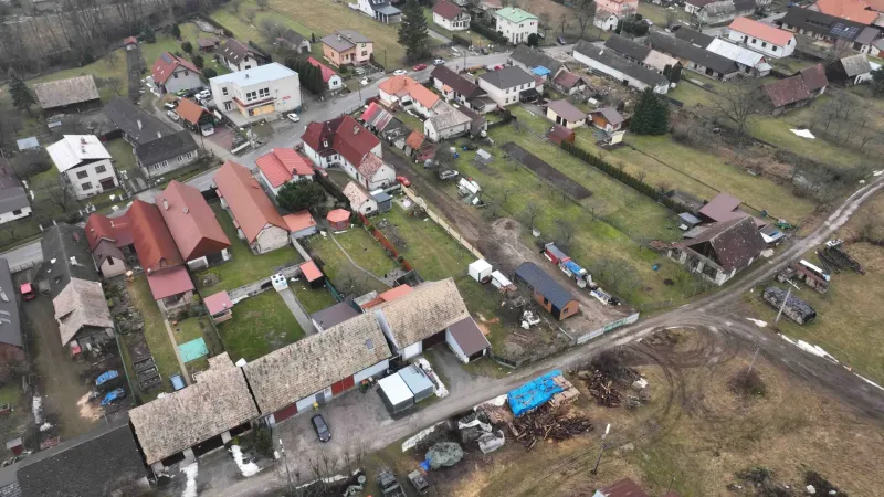 Aerial view of unusual properties in Kláštor pod Znievom with gardens and buildings.