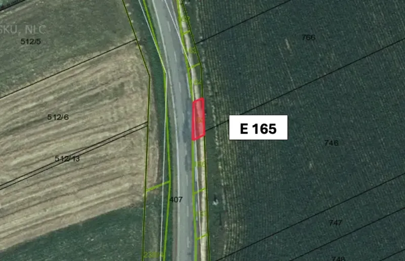 Aerial view of plots, agricultural and forest land in Hankovce near the road.
