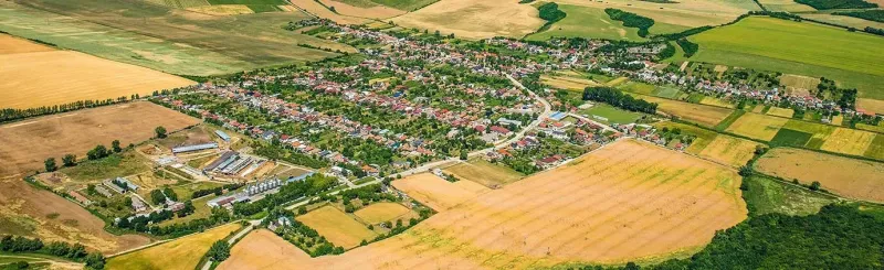 Aerial view of the landscape and gardens in the village of Dvorníky - Včeláre, surrounded by fields.