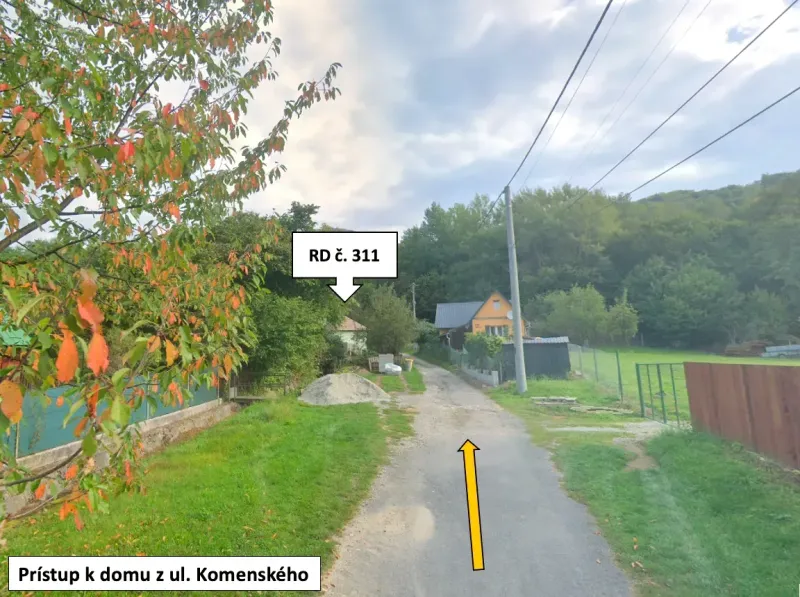 Access road to a family house in Kokava nad Rimavicou, surrounded by greenery and trees.