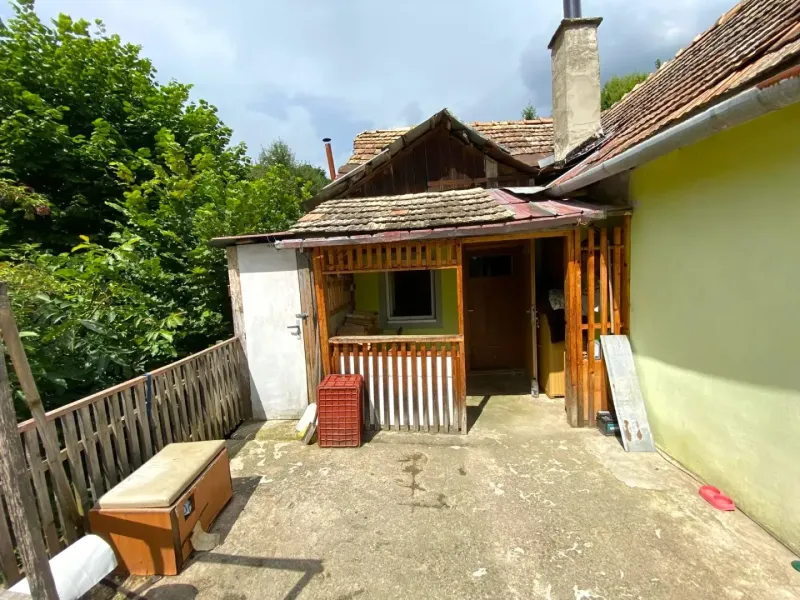 A family house in Kokava nad Rimavicou with a terrace, wooden railing, and surroundings full of greenery.