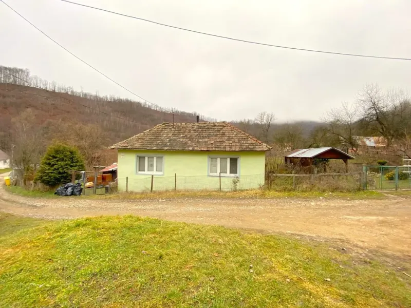 A family house in Kokava nad Rimavicou, with a wooden roof, situated by the road.