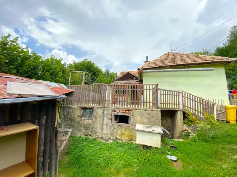 A family house in Kokava nad Rimavicou with a wooden fence and a grassy yard.