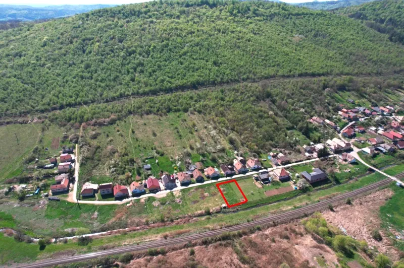 Lands - housing in Hodejov, bordered by green hills and a railway track.