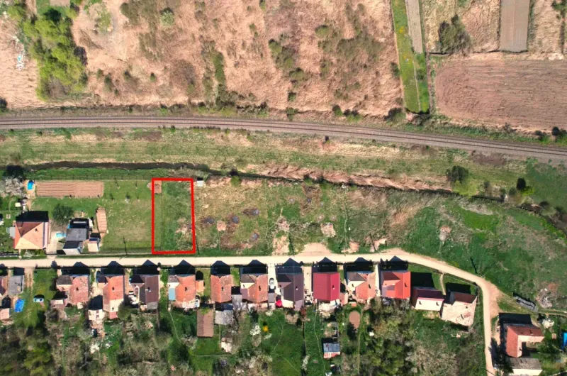 Plots - housing in Hodejov near the railway track with village houses and green area.