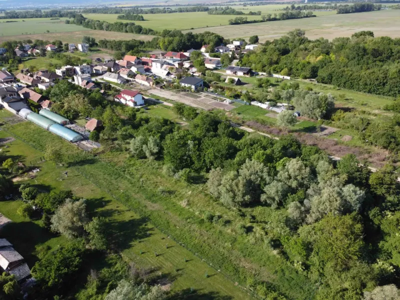 Aerial view of the garden area around the town of Branč, surrounded by greenery.