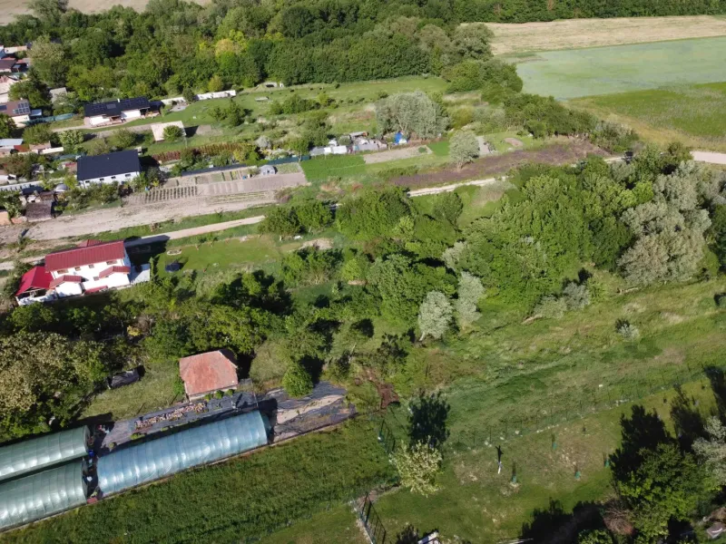 Aerial view of the Gardens in Branč with multiple buildings and greenery.