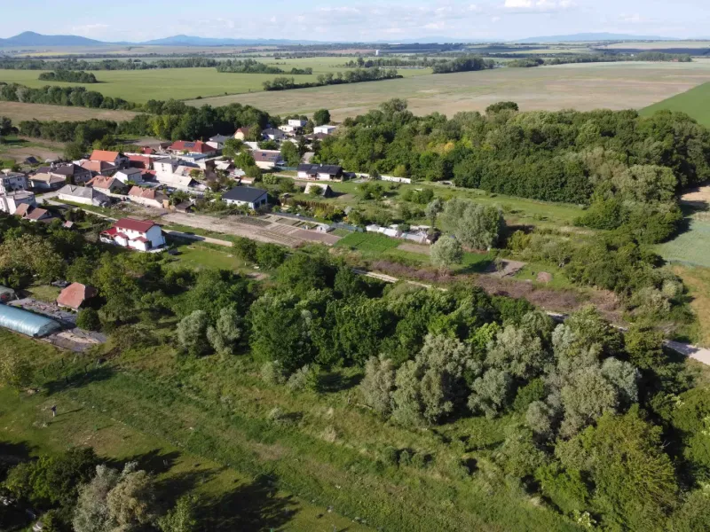 Aerial view of the Gardens in Branč, surrounded by greenery and fields.