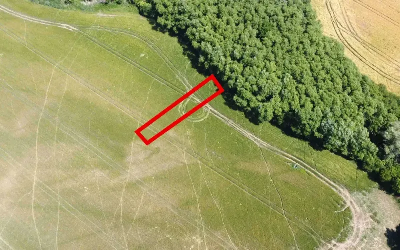 An aerial view of agricultural and forest land in Kozárovce with a highlighted rectangle.