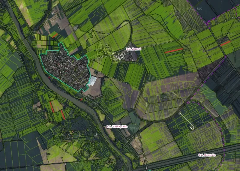 Aerial view of agricultural and forest lands around the town of Zemné.