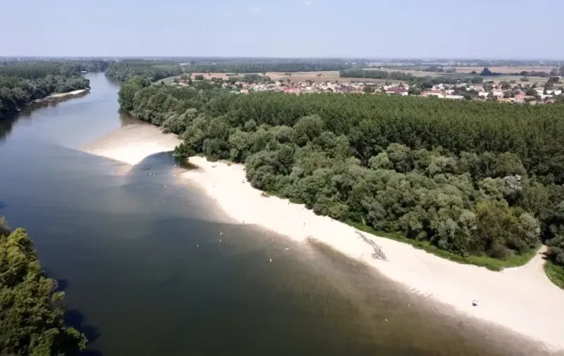 Aerial view of agricultural and forest land near the river in Zemné.