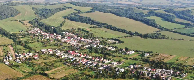 An aerial view of Rovné surrounded by agricultural and forest lands.