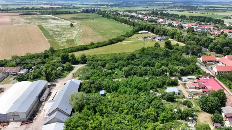 Aerial view of properties - housing in Parchovany with green fields and buildings.