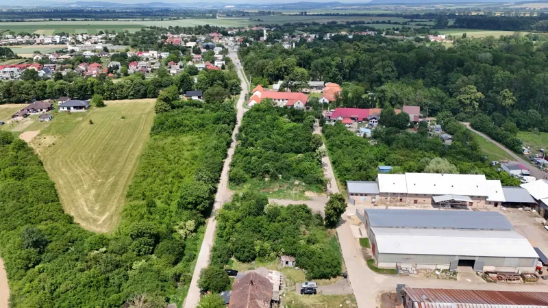 A view of residential plots in Parchovany, surrounded by greenery and buildings.