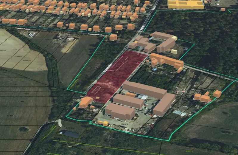 An aerial view of residential plots in Parchovany surrounded by buildings and fields.