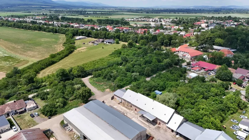 An aerial view of Parchovany shows plots - housing surrounded by greenery and buildings.