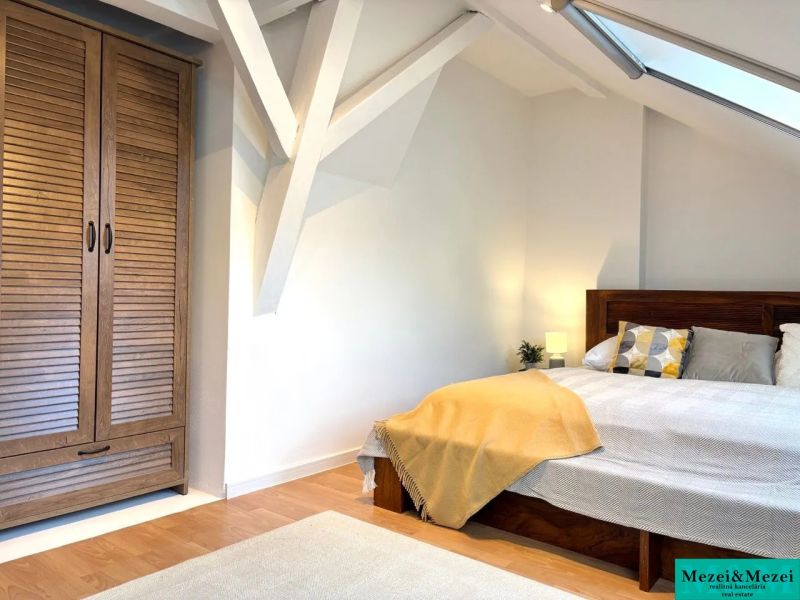 Bright bedroom in a 4-room apartment with a wooden wardrobe and a floor with a wooden decor.