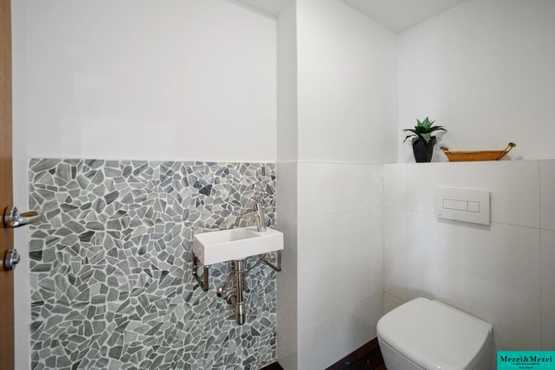 A bathroom with stylish mosaic tiles in a 4-room apartment.