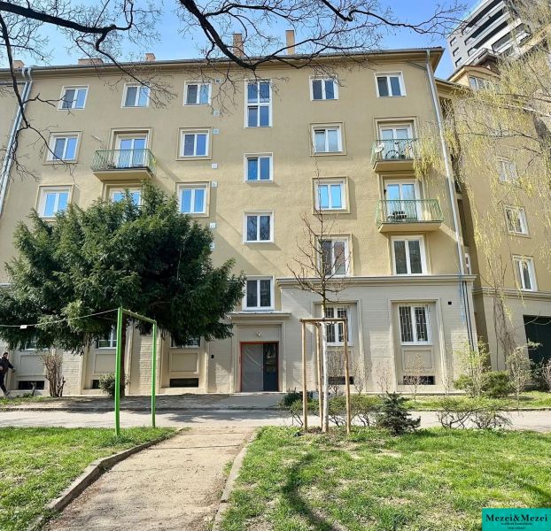 Residential building in Bratislava - Old Town with a green front garden and trees.