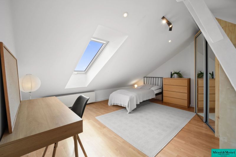 Attic room with a skylight, bed, and desk, 4-room apartment.