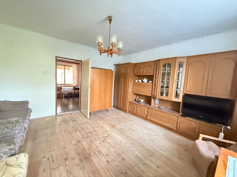 Living room in a family house with a wooden decor floor and a living room wall unit.
