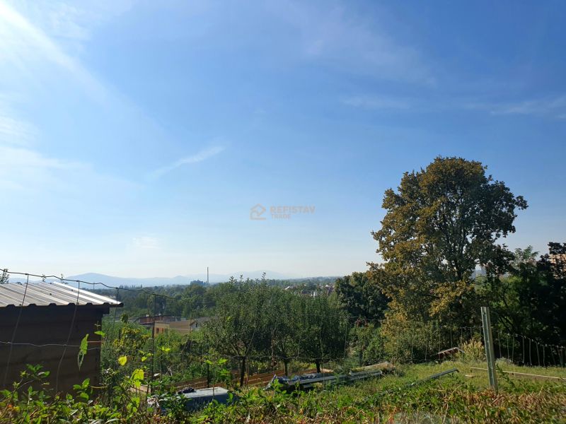 View of the gardens in Košice - Krásna district, 1st May Street with a blue sky.
