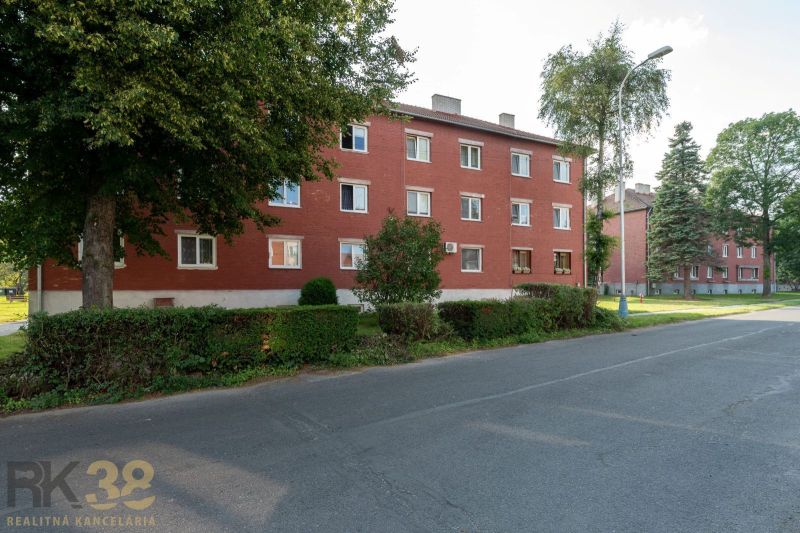 Red brick building surrounded by greenery on 9th May Street in the town of Svit.