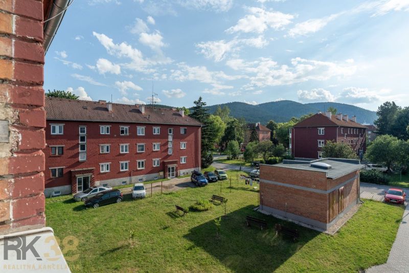 Brick buildings with parking and greenery in Svit on 9. mája Street, ideal for a 1-room apartment.