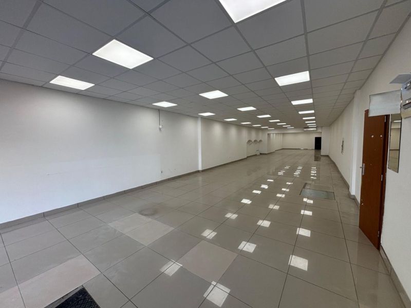 Commercial spaces with light floors and white walls, available for rent.