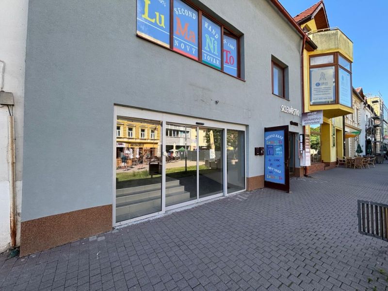 Commercial premises on St. Egidius Square, Poprad, with a glass facade and paving in front of the entrance.