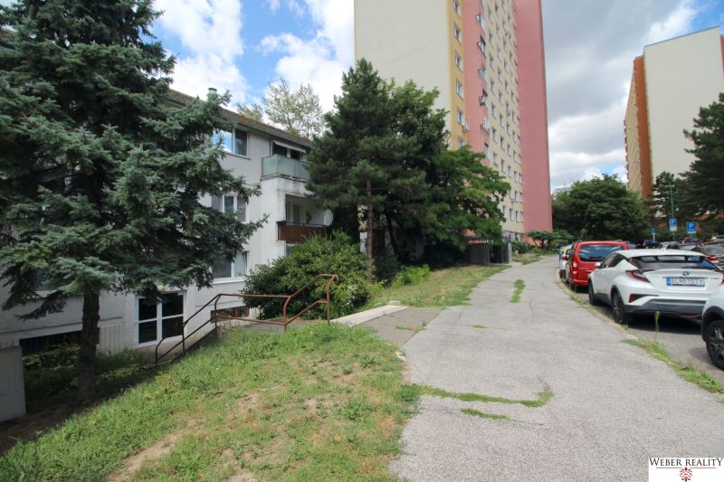 A view of the apartment building on Talichova Street in Bratislava - Dúbravka with a parking lot.