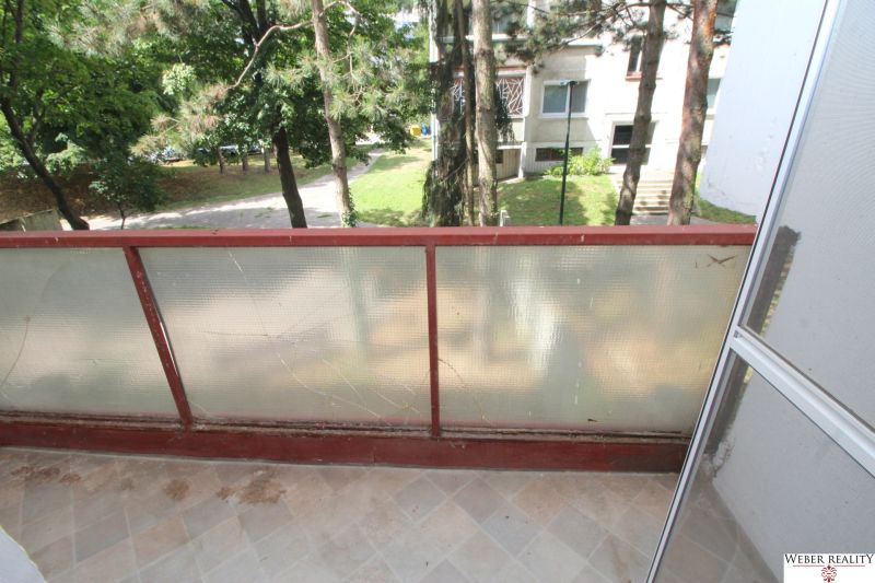 The balcony of a 2-room apartment with a view of greenery on Talichova Street in Bratislava - Dúbravka.