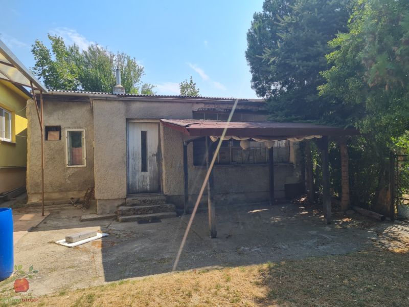 A family house in Komjatice with a neglected outdoor area and a shelter.