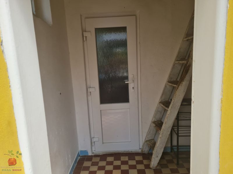 Entrance to a family house in Komjatice with stairs and doors.
