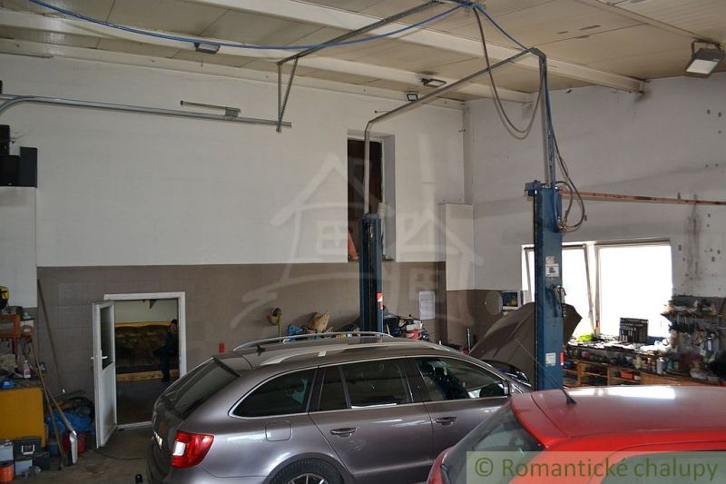 A garage in a family house with cars and a car lift, floor with wooden decor.