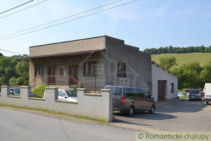A family house in Varadka with a concrete fence and landscaped surroundings.