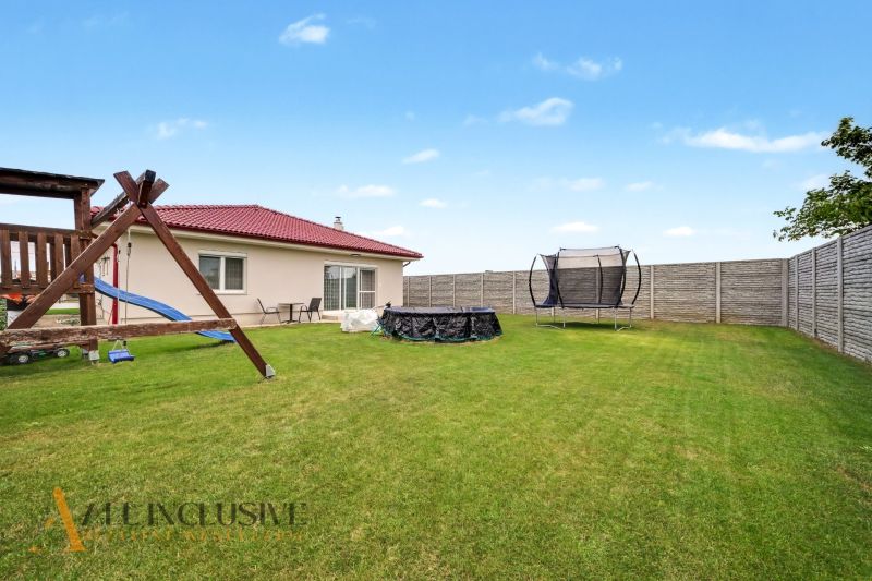 A family house in Vozokany with a trampoline and a gazebo on the lawn.
