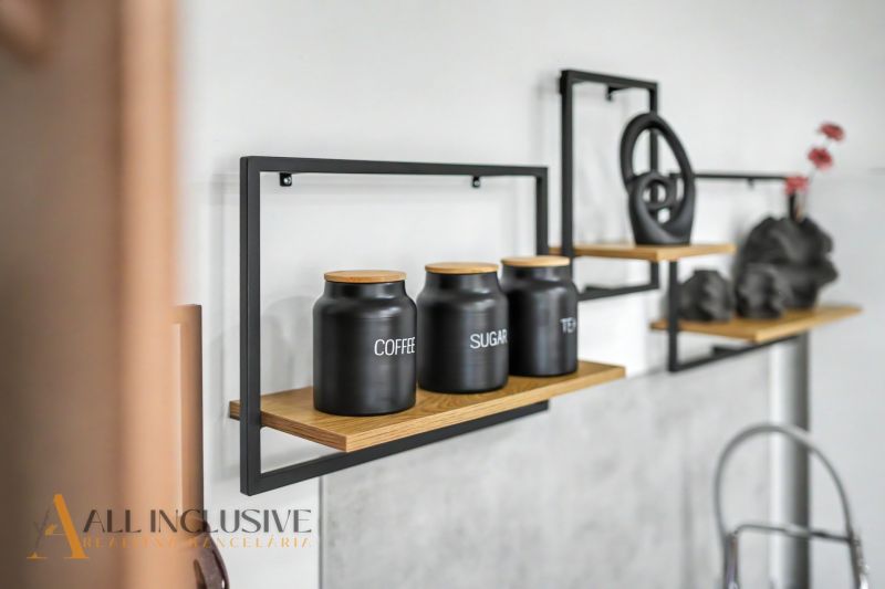 Black canisters for coffee, tea, sugar on a shelf in a family house.