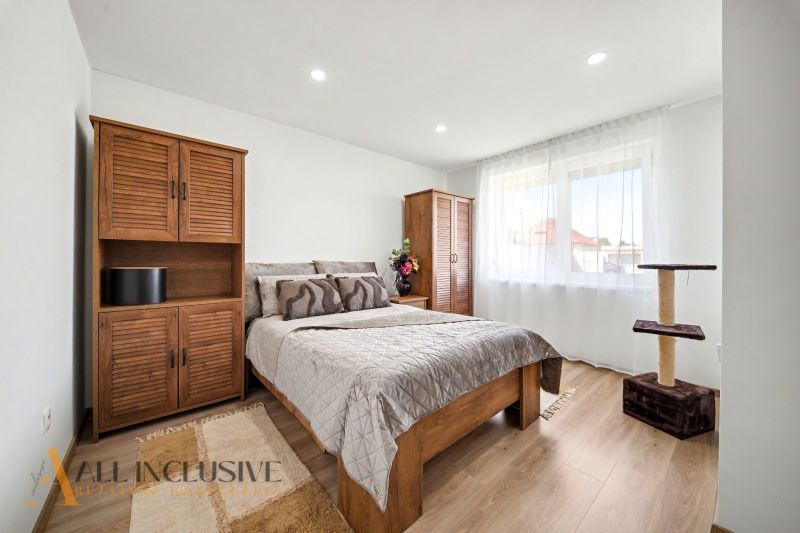 A bedroom in a family house with wooden decor and plenty of natural light.